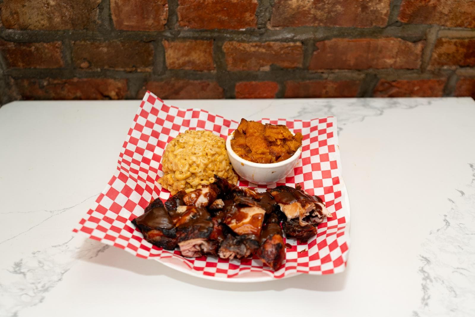 Jerk chicken shown with rice and yams