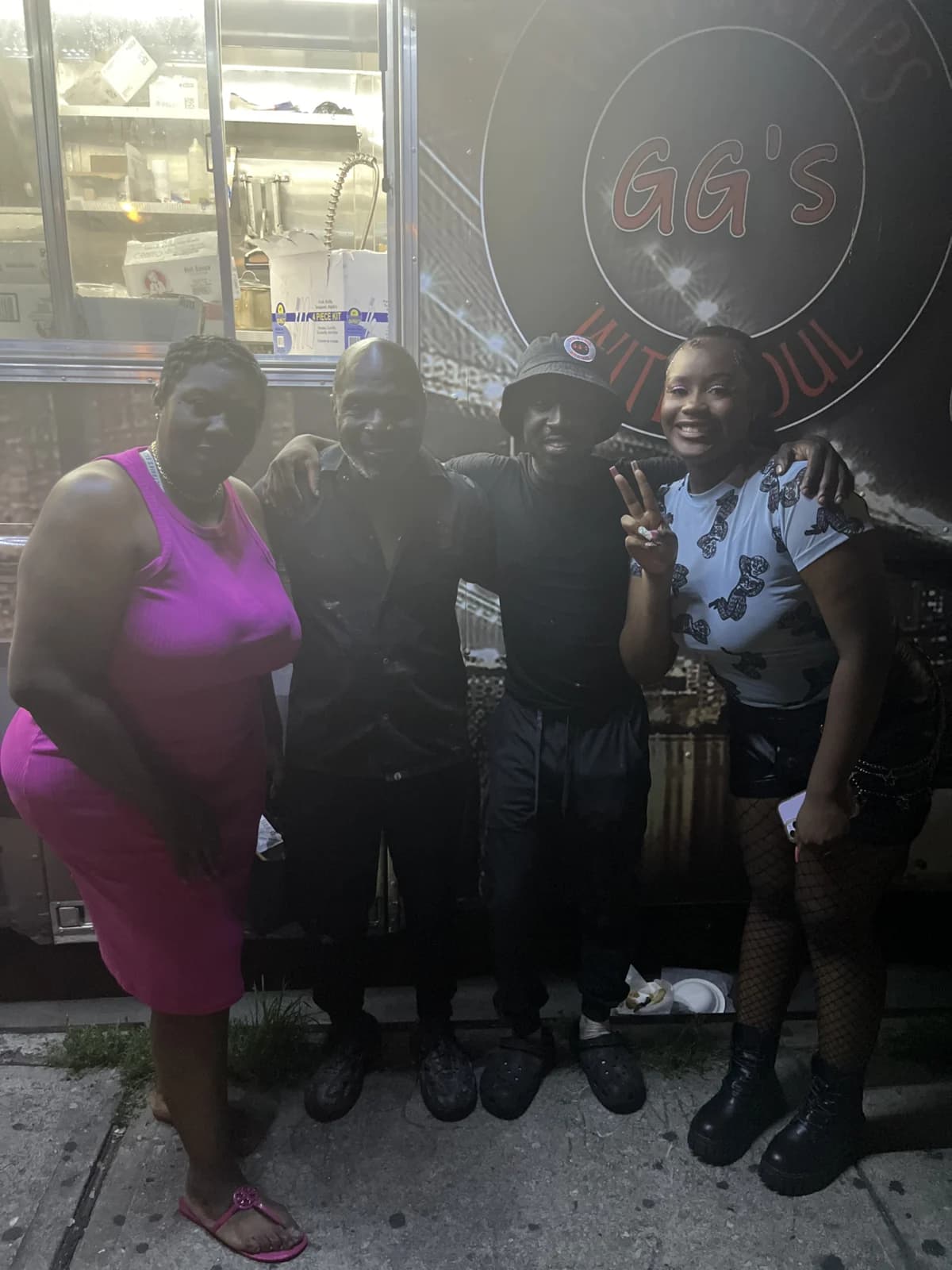 A group gathered beside a GG’s food truck